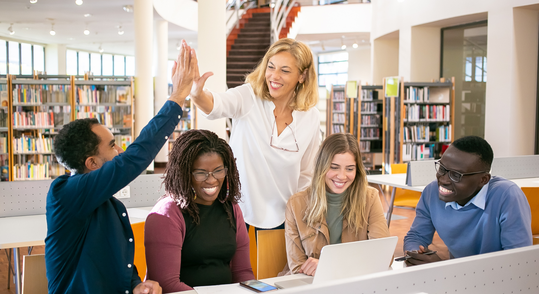 photo fo 5 teachers huddled around a computer and 2 teacher giving each other a high 5 photo fo 5 teachers huddled around a computer and 2 teacher giving each other a high 5